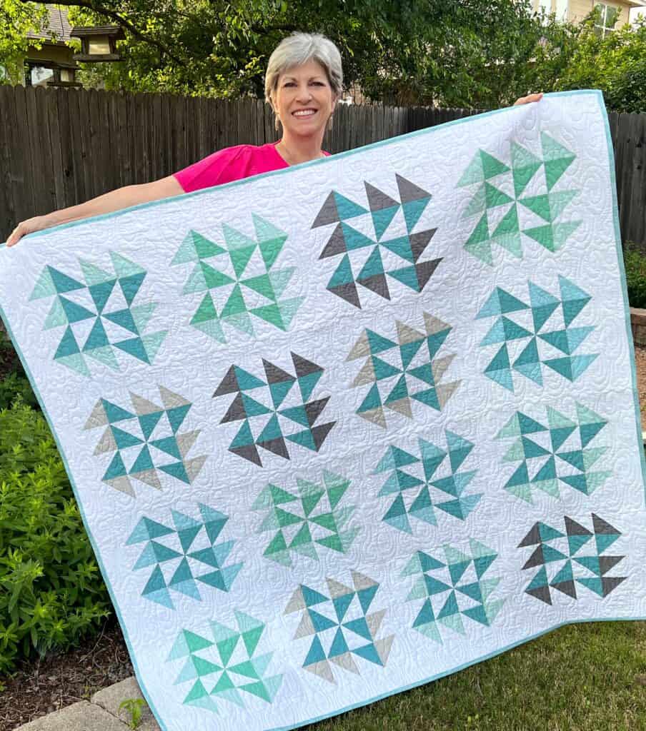 Me holding a Tumbling Sea Glass Quilt