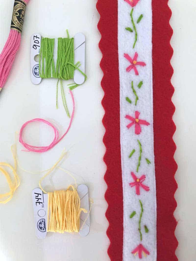 Using embroidery floss, stitch the floral design on the white felt.