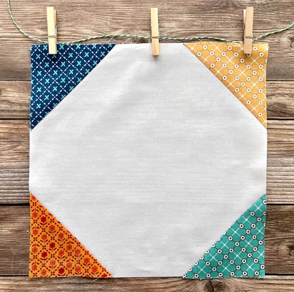 Easy Snowball Quilt Block on wooden background