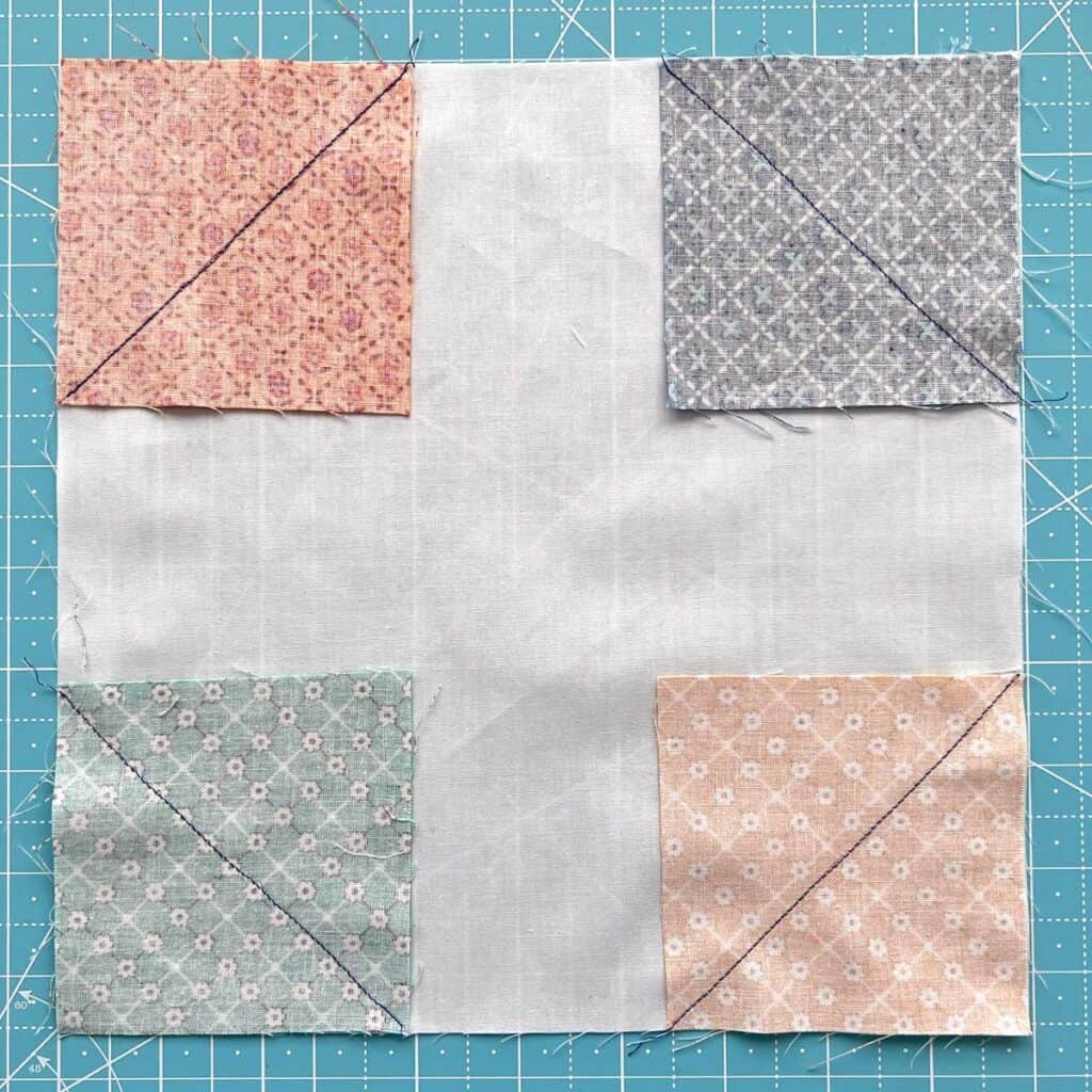 All of the snowball quilt block corners are sewn down.